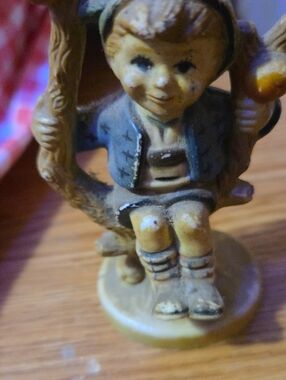 Vintage-style Boy on Swing Figurine in Muted Blue and Tan